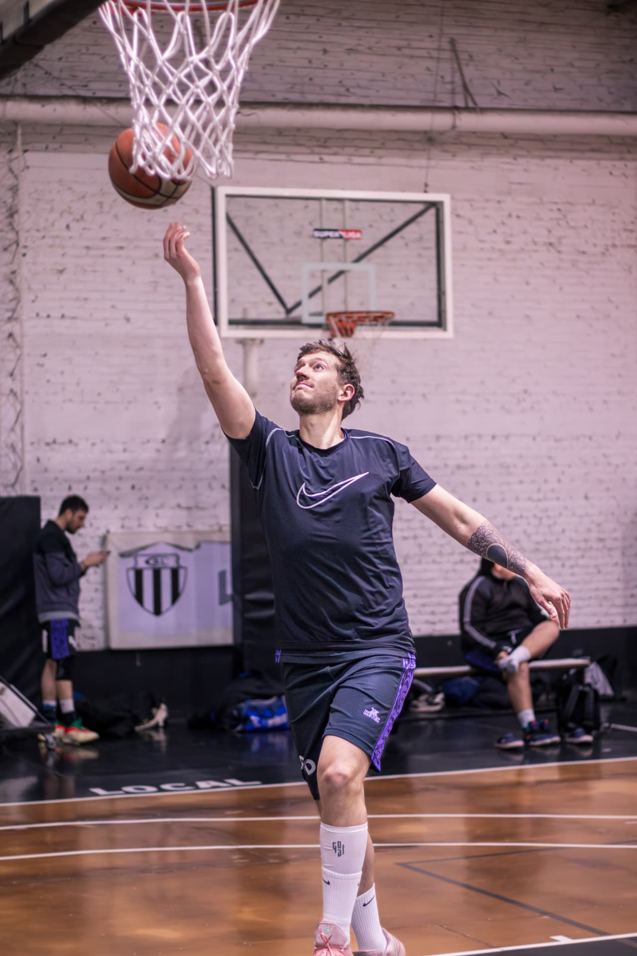Jugador de básquet definiendo debajo del aro en entrada en bandeja